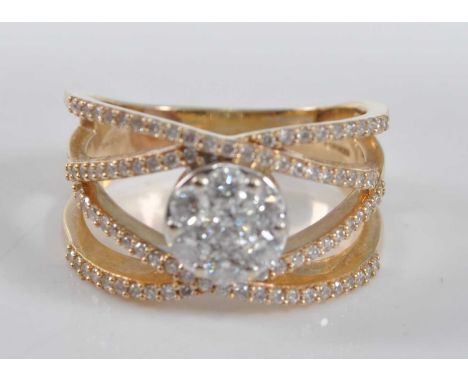 A yellow metal four-strand diamond crossover ring by Frederic Sage, featuring a centre circular cluster with seven round bril