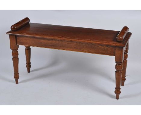 A Victorian style oak window seat, having turned ends and on ring turned tapering supports, w.94cm, d.34cm, seat h.47cm
