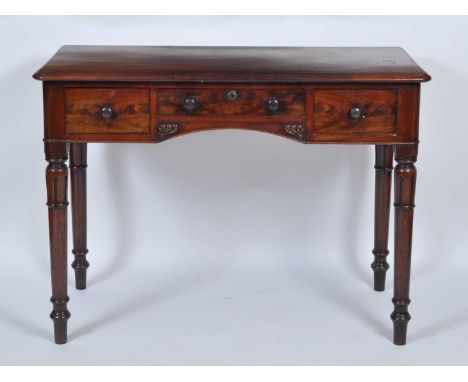 A William IV mahogany side table, having three frieze drawers and raised on tulip carved ring turned tapering supports, w.107