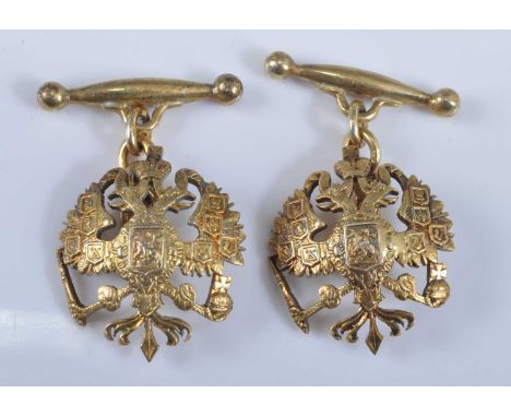 A pair of yellow metal Russian Imperial double-headed eagle cufflinks, each featuring an engraved openwork design with chain 