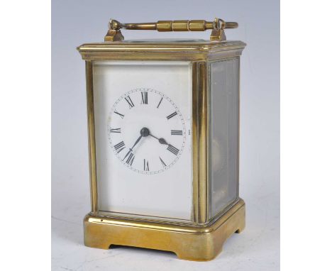 A circa 1900 brass carriage clock, having unsigned white enamel Roman dial, visible platform escapement, twin barrel going ei