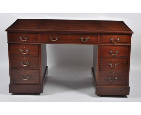 A Victorian walnut twin pedestal desk, having a gilt tooled brown leather inset writing surface above an arrangement of nine 