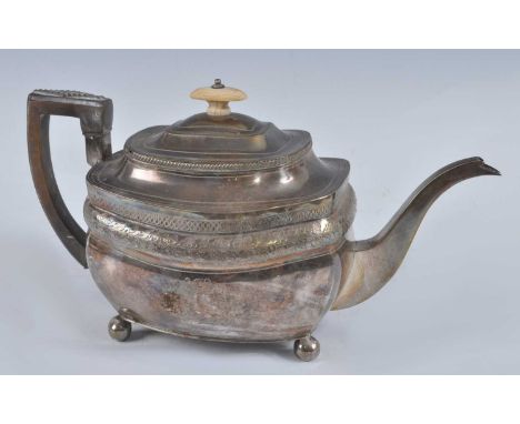 A George III silver teapot, of shaped rectangular form with engraved banded decoration, walnut handle and finial, standing on
