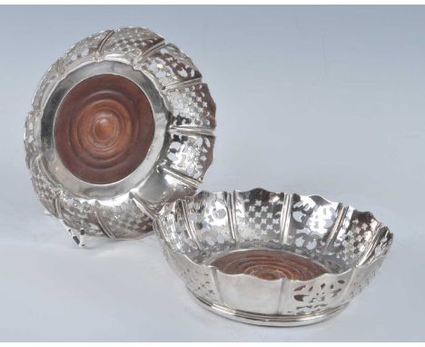 A pair of probably Victorian pierced silver-plated coasters, of deep circular form with alternate cross-hatch and scroll pier