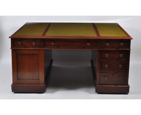 A Victorian mahogany twin pedestal partner's desk, having a triple inset gilt tooled leather writing surface, above three fri