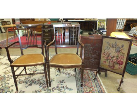 An Edwardian ivory and boxwood inlaid mahogany armchair, another with plain spindle back on turned legs, a carved wood fire s