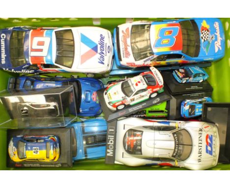 A collection of unboxed Ertl, Maisto and other scale model racing cars, various scales, (14).