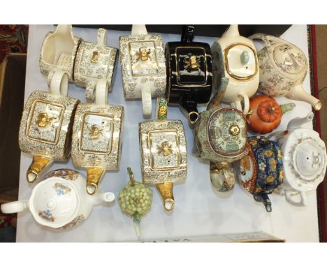 A Sadlers Cottage Garden teapot, sugar basin and jug of oval form, three similar teapots and others.