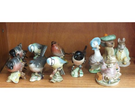 A collection of seven Beswick small bird models: Whitethroat, Bullfinch (x2), Blue Tit (x2), Stonechat, Robin and a Goebel mo