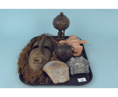 Various ethnic wooden and ceramic face masks and figures including an African medicine man figure