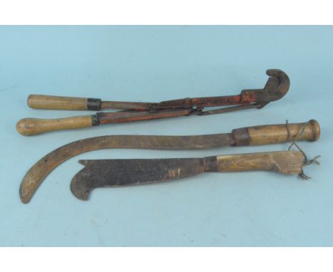 Three agricultural tools including a scythe, bill hook and lopper