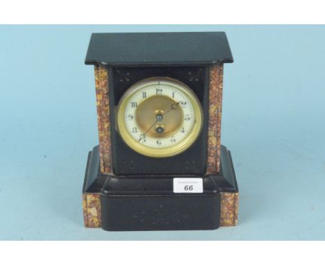 A black marble mantel clock with red marble detailing, brass and enamel dial