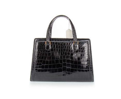HERMÉS,  PULLMAN HANDBAG, PARIS, CIRCA 1960/70s  in black crocodile skin leather with brass hardware, stamped HERMÉS PARIS to
