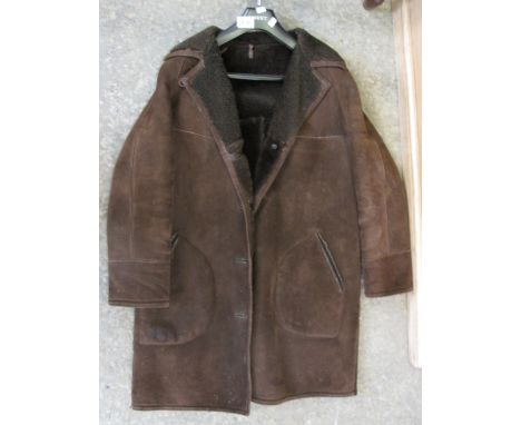 Dark brown knee length vintage sheepskin coat with 'a real sheepskin product by Baily's Glastonbury' label. (B.P. 24% incl. V