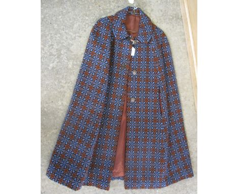 Vintage brown ground Welsh tapestry knee length cape with metal Welsh dragon buttons and 'designed by Catherine Poulson, Made