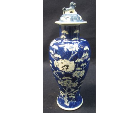 19th Century Chinese porcelain baluster shaped vase and cover overall decorated with prunus blossom on a cracked ice cobalt b