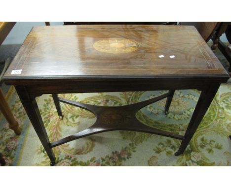 19th Century rosewood inlaid folding card table with under tier on tapering legs and casters. (B.P. 24% incl. VAT)