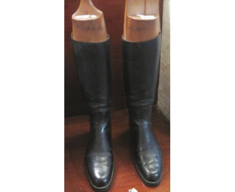 Pair of vintage black men's riding boots with matching wooden boot trees and a yellow metal tag that says 'Monet'. (B.P. 24% 
