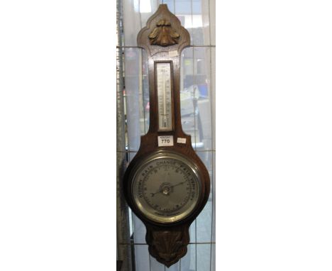 20th Century oak relief foliate carved aneroid barometer. (B.P. 24% incl. VAT)