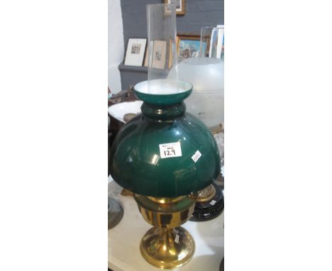 Brass oil lamp with green overlay glass shade and clear chimney. (B.P. 24% incl. VAT)  