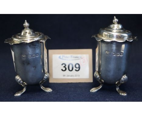 Pair of silver straight sided pepperettes with pierced step covers on paw feet, Sheffield hallmarks, 2.2 troy ozs approx. (2)