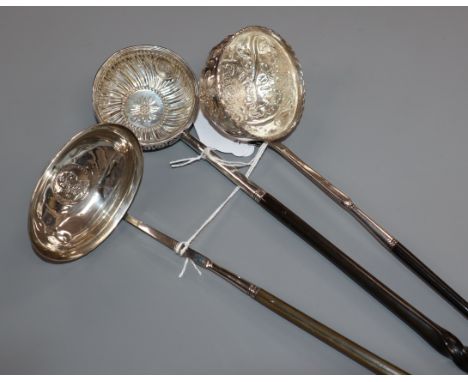 A Georgian coin-set toddy ladle with plain oval bowl and whalebone handle and two other toddy ladles with whalebone handles a