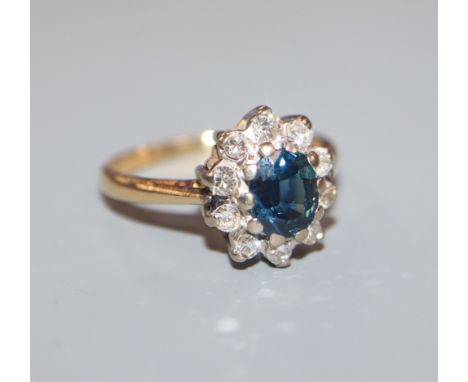 An 18ct gold,, sapphire and diamond oval cluster ring, size K.