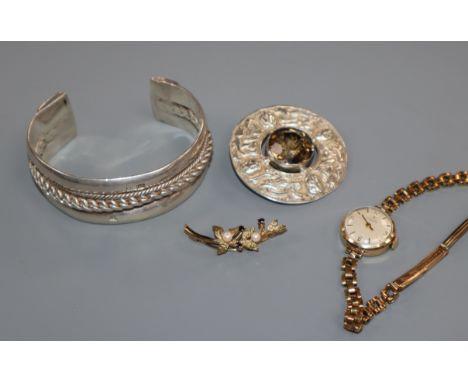 A Scottish silver and citrine brooch, a white metal bangle and a Tissot wrist watch and a 9ct gold brooch.