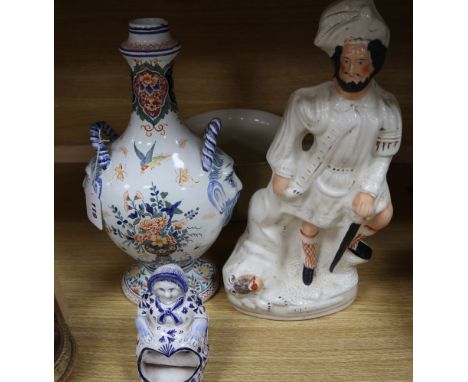 A French faience pilgrim flask, a delft figure, a Staffordshire figure and Victorian chamberpot