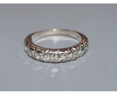 A modern 18ct white gold and ten stone diamond set half eternity ring, size L/M.