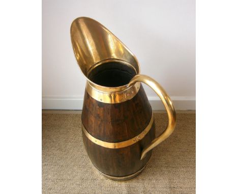 An oak and brass jug stick stand height 66cm