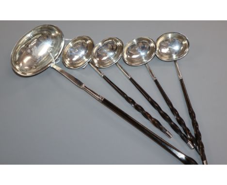 Four George III small silver toddy ladles with whalebone handles and a similar larger ladle (probably a matched set), maker p