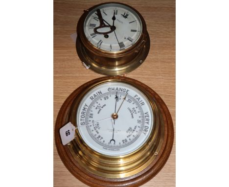 A ship's aneroid barometer and a bulkhead clock