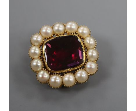 An early Victorian yellow metal, foil backed garnet and split pearl brooch, 22mm.
