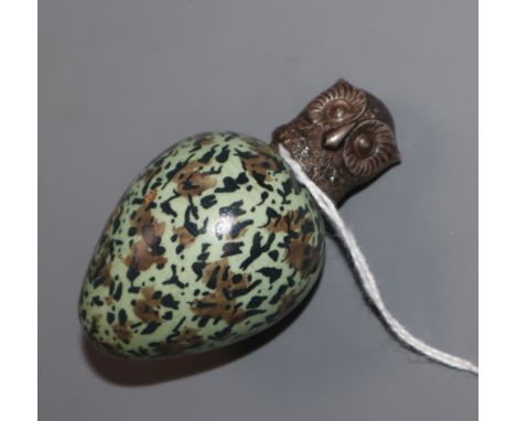 A Victorian novelty ceramic scent flask in the form of an egg with screw-on white metal top modelled as an owl, flask and top