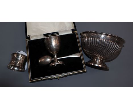 A late Victorian silver christening bowl, a cased egg cup and spoon set and a napkin ring.