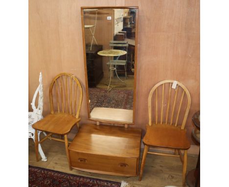 An Ercol elm cheval mirror and two Ercol comb back chairs