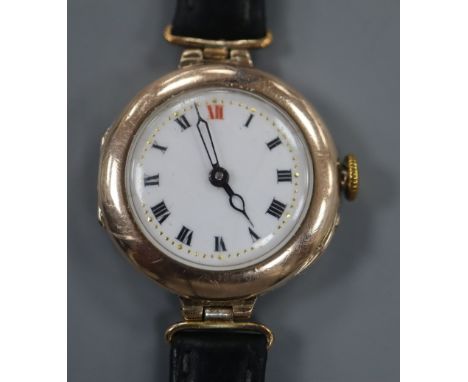 A lady's early 20th century 9ct gold manual wind wrist watch, on associated black leather strap.