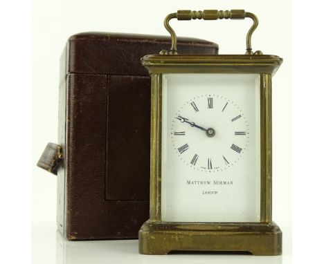 A modern brass cased carriage clock by Matthew Norman of Switzerland, case height 11cm in leather travelling case.