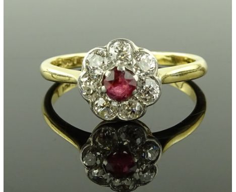 An 18ct gold and platinum ruby and diamond flowerhead cluster ring, ruby approx. 0.14cts, setting height 9.6mm, 3.4g, size Q.