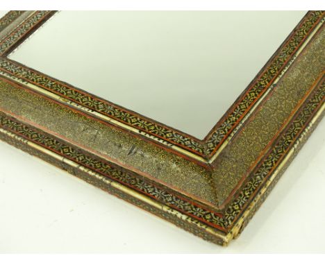 A 19th century Islamic ivory and gilded cushion framed wall mirror, height 37cm.