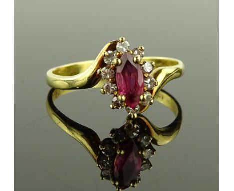 An 18ct gold ruby and diamond cluster ring, setting height 9.5mm, size M, 2.6g.