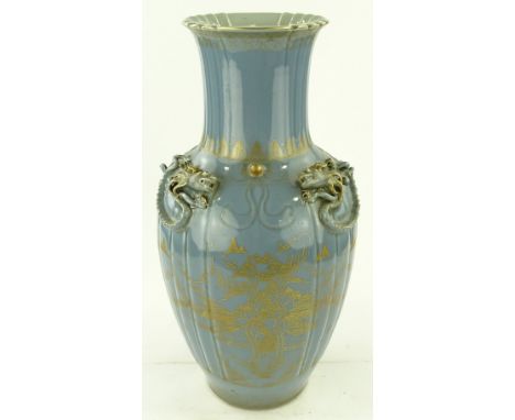 A large Chinese pale blue glazed porcelain vase, applied dragon decorated shoulders with gilded landscape designs, painted se