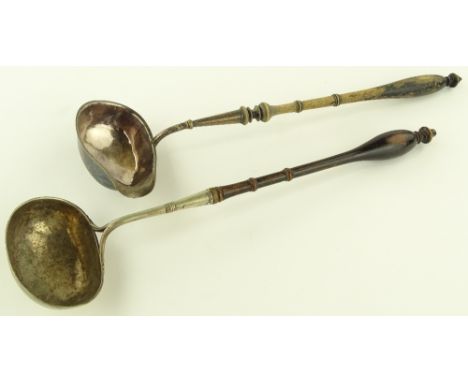 A Swedish silver ladle with turned wood handle, another continental ladle and a small Swedish drinking tot, (3).