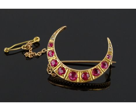 A Victorian ruby and diamond crescent brooch, unmarked gold settings, length 28.8mm, 4.6g.