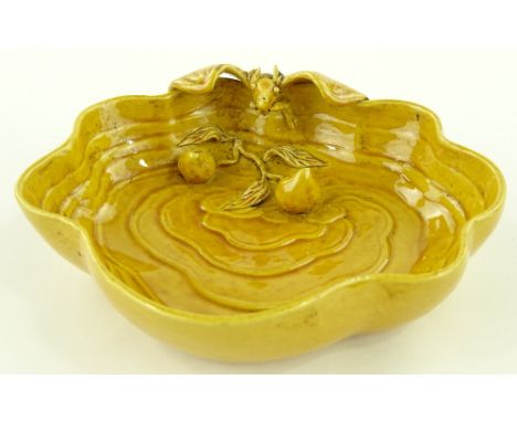 A Chinese yellow glazed porcelain dish surmounted by a bat, painted seal mark under base, width 16cm.