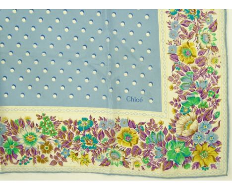 A Chloe Paris silk scarf, blue and white spots with floral border, width 82cm.