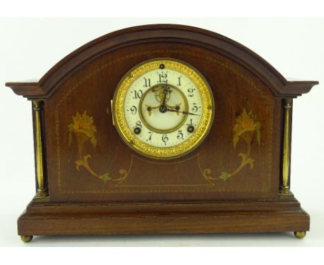 An Edwardian mahogany and marquetry inlaid domed top mantel clock with brass columns and 8-day striking movement, width 39cm.