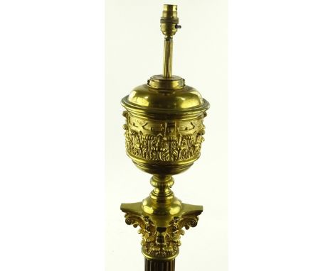 A Victorian Messenger's patent brass Corinthian column standard lamp, on brass lion paw feet, converted to electric, height e