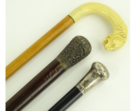 An English silver topped walking cane, a 19th century cane with ornate unmarked white metal top and a Malacca walking stick w